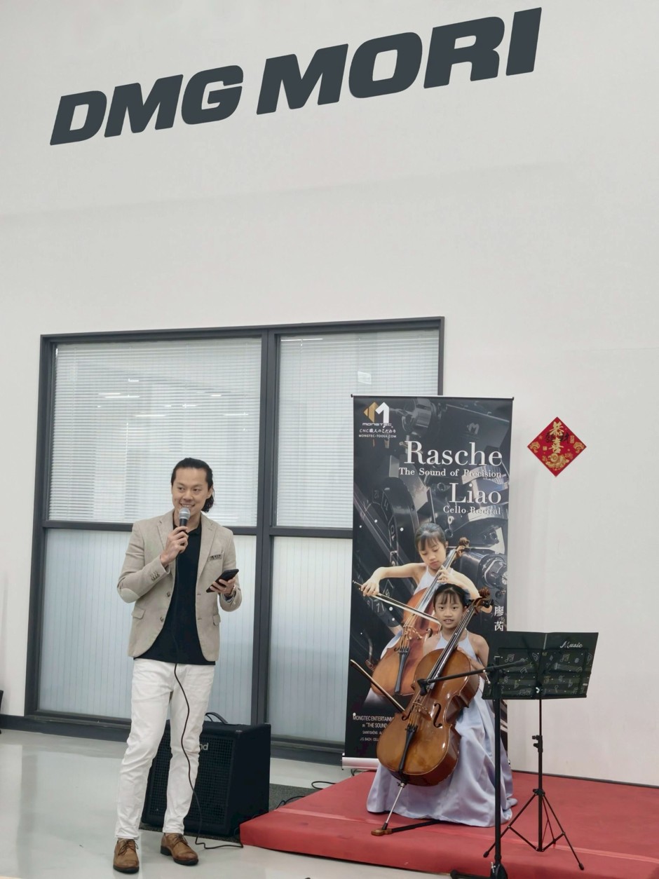 Mongtec Precision General Manager Jun Liao speaking at DMG MORI seminar beside Rasche Liao cello recital banner